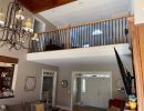 Remodel of railings overlooking large living room.